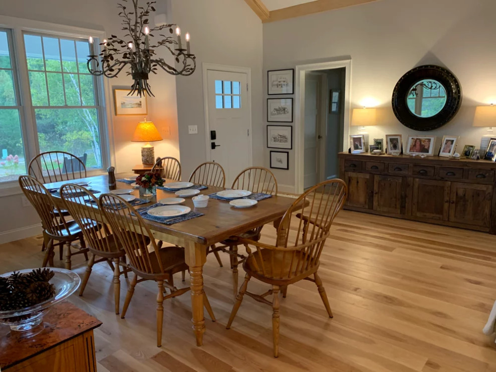 Traditional dining room in Other with medium hardwood floors and exposed beam.