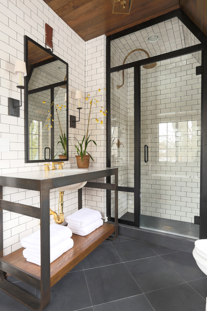 Inspiration for a transitional bathroom in Chicago with subway tile and black floor.