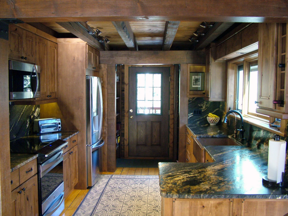 Mid-sized mountain style u-shaped light wood floor kitchen pantry photo in Denver with a farmhouse sink, flat-panel cabinets, dark wood cabinets, granite countertops, black backsplash, stone slab backsplash, stainless steel appliances and no island