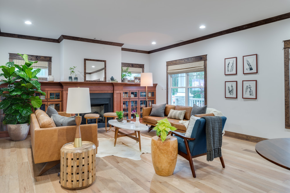 Mid-sized arts and crafts formal open concept living room in Seattle with white walls, light hardwood floors, a standard fireplace and no tv.