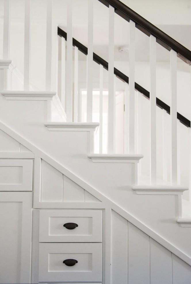 This is an example of an arts and crafts straight staircase in San Diego with wood railing.