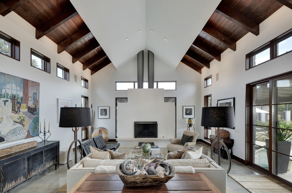Inspiration for a country formal enclosed living room in Austin with white walls, concrete floors, a standard fireplace and grey floor.