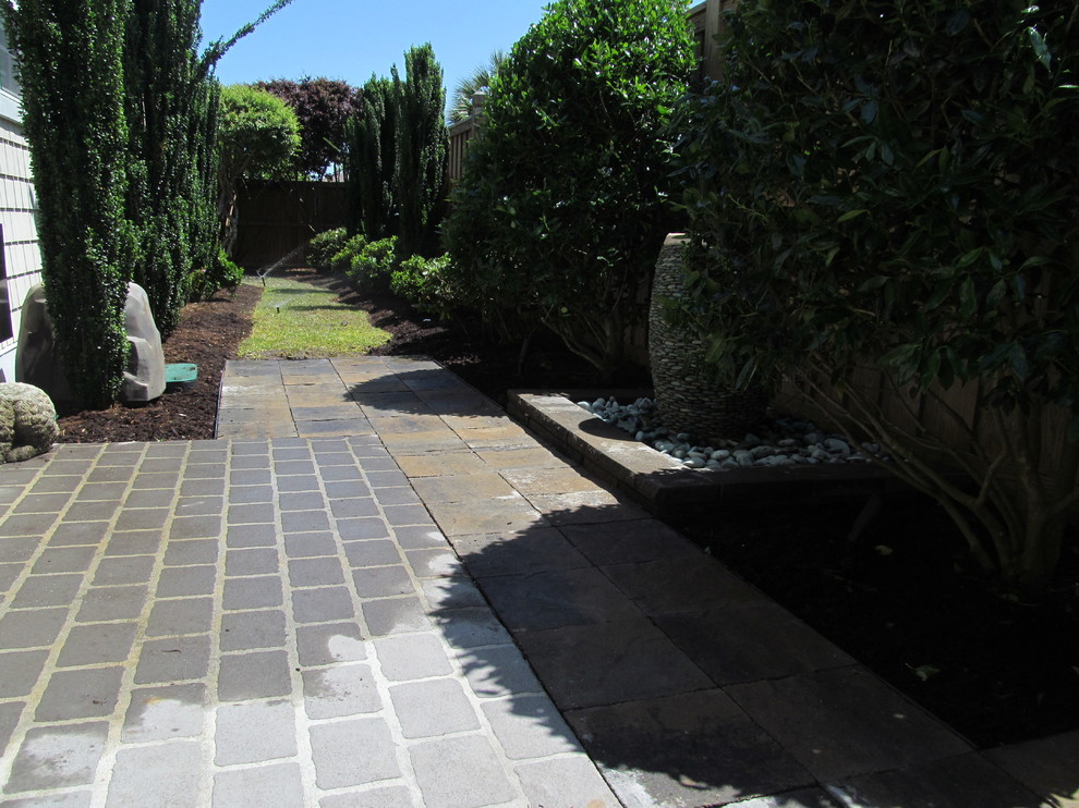 Design ideas for a small mediterranean side yard partial sun garden for summer in Other with a garden path and natural stone pavers.