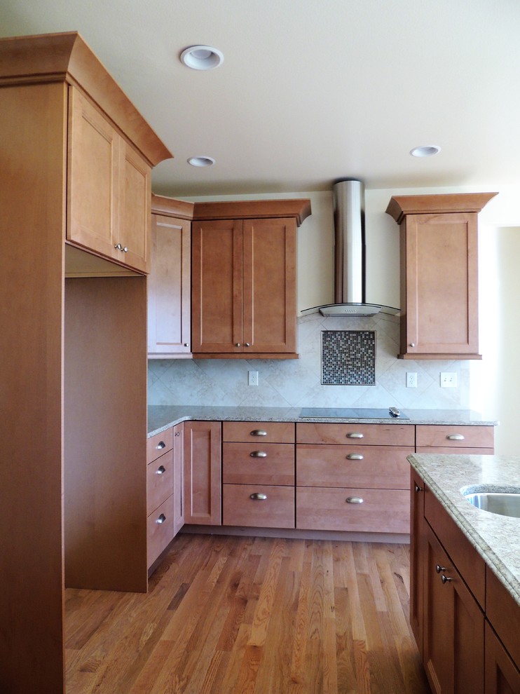Example of a large transitional u-shaped light wood floor eat-in kitchen design in Seattle with recessed-panel cabinets, medium tone wood cabinets, multicolored backsplash, mosaic tile backsplash, stainless steel appliances, an island and quartz countertops