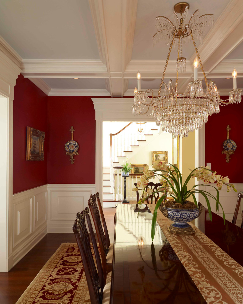 Photo of a large traditional separate dining room in New York with red walls and medium hardwood floors.