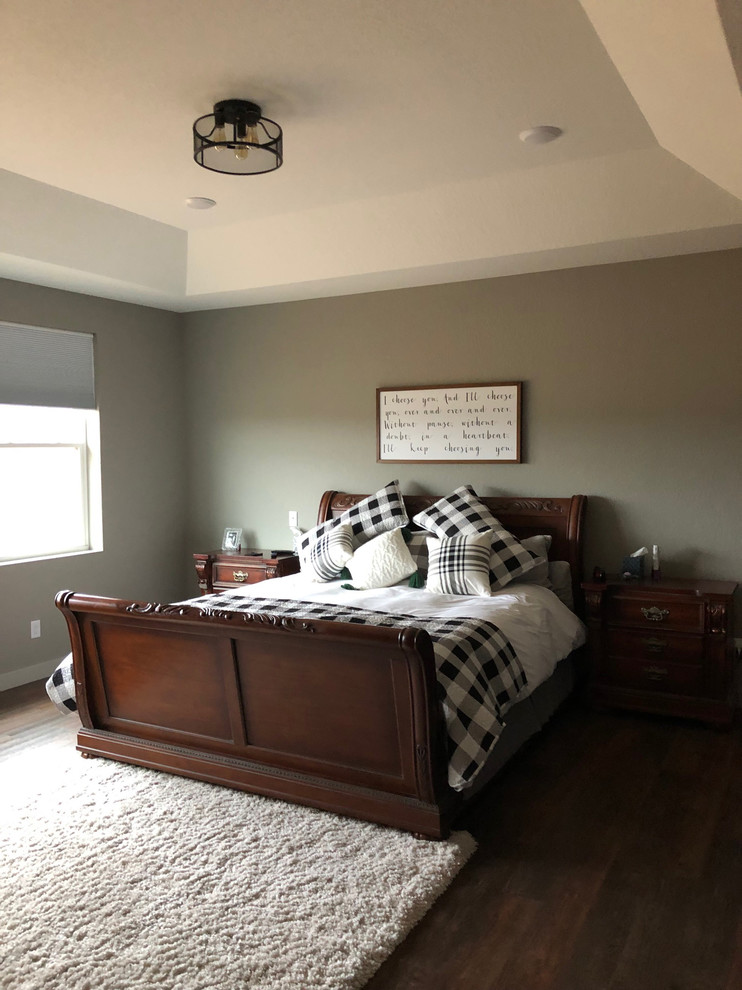 This is an example of a large industrial master bedroom in Other with beige walls, vinyl floors and brown floor.