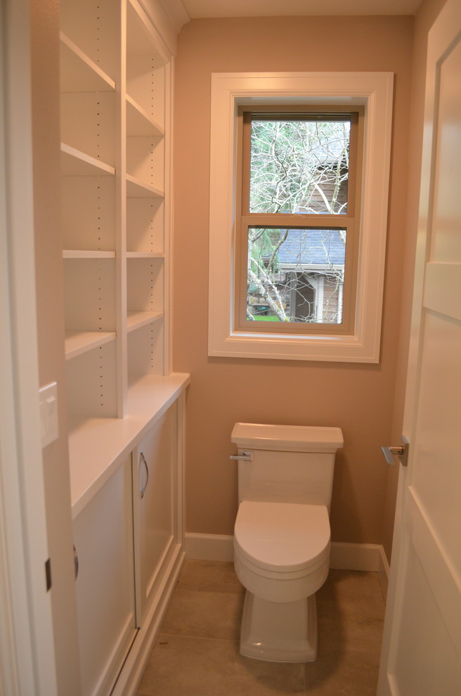 Large traditional powder room in Portland with shaker cabinets, white cabinets, a one-piece toilet, grey walls, ceramic floors, an undermount sink and solid surface benchtops.