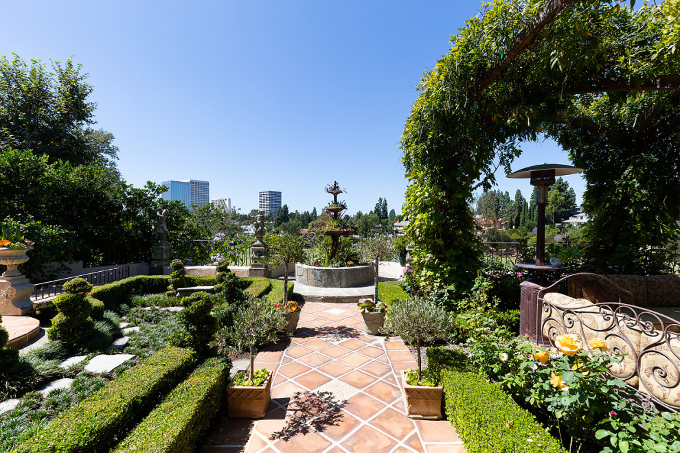 Design ideas for an expansive country backyard full sun formal garden in Orange County with a garden path.