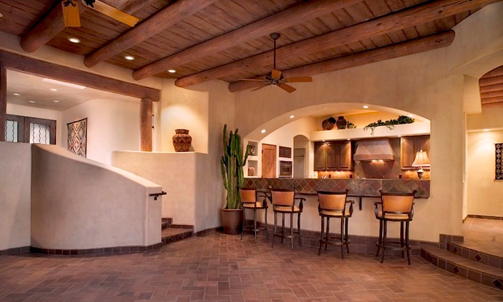 Photo of a mid-sized contemporary home bar in Phoenix with brick floors.