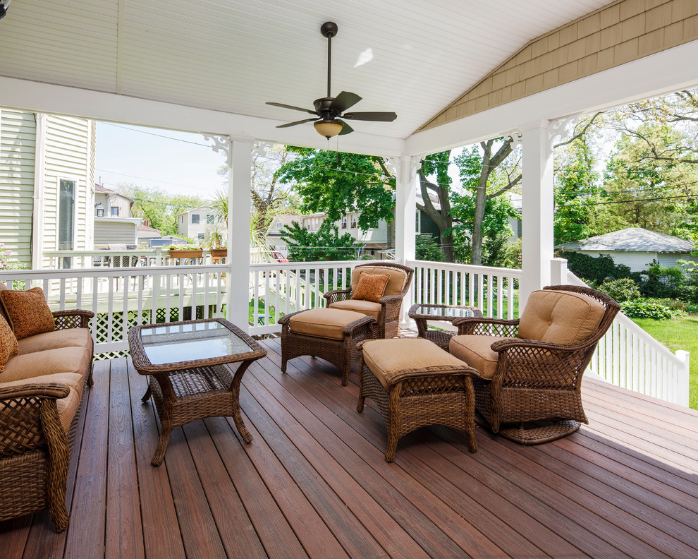 Large beach style backyard deck in Philadelphia with a roof extension.