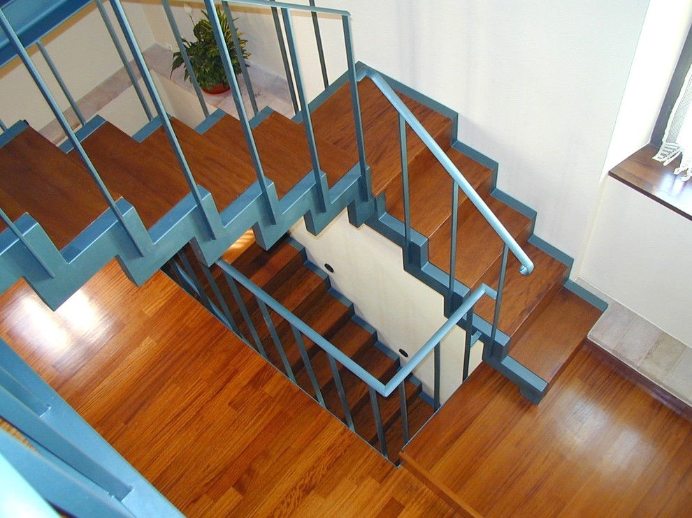 Small country wood l-shaped staircase in Other with wood risers and metal railing.