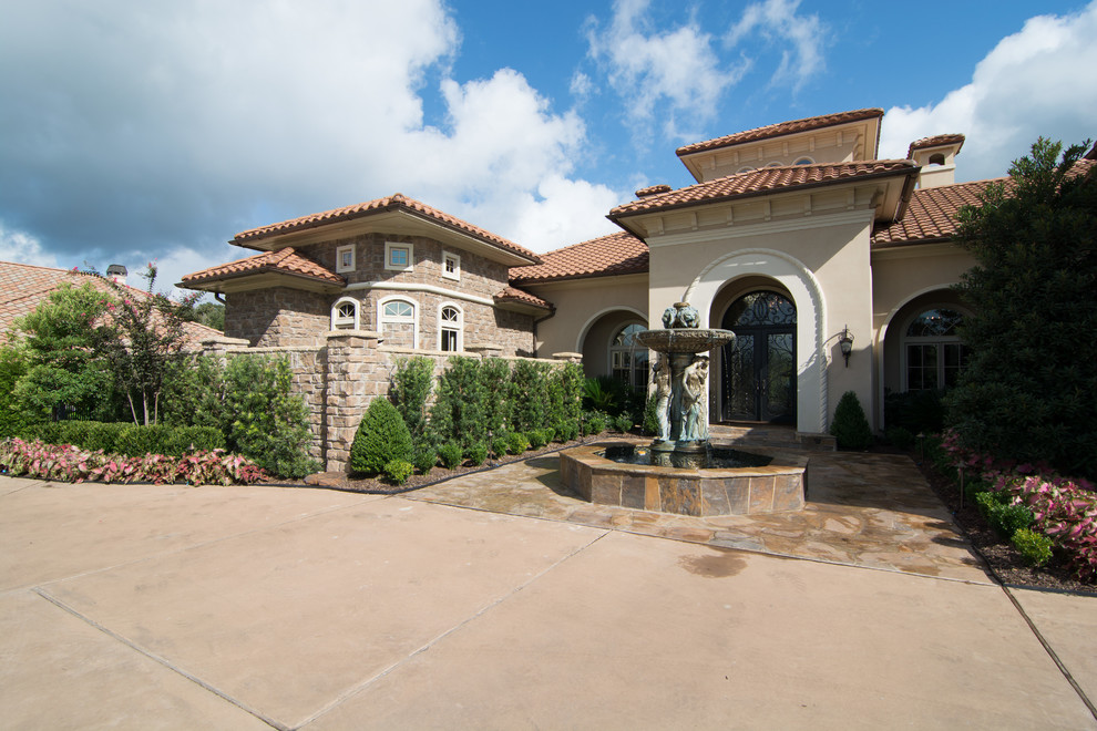 Design ideas for an expansive mediterranean two-storey beige exterior in New Orleans with stone veneer.