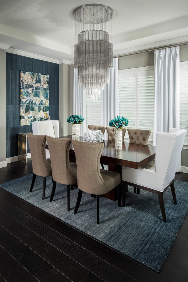 Inspiration for a transitional dining room in Orlando with grey walls and dark hardwood floors.