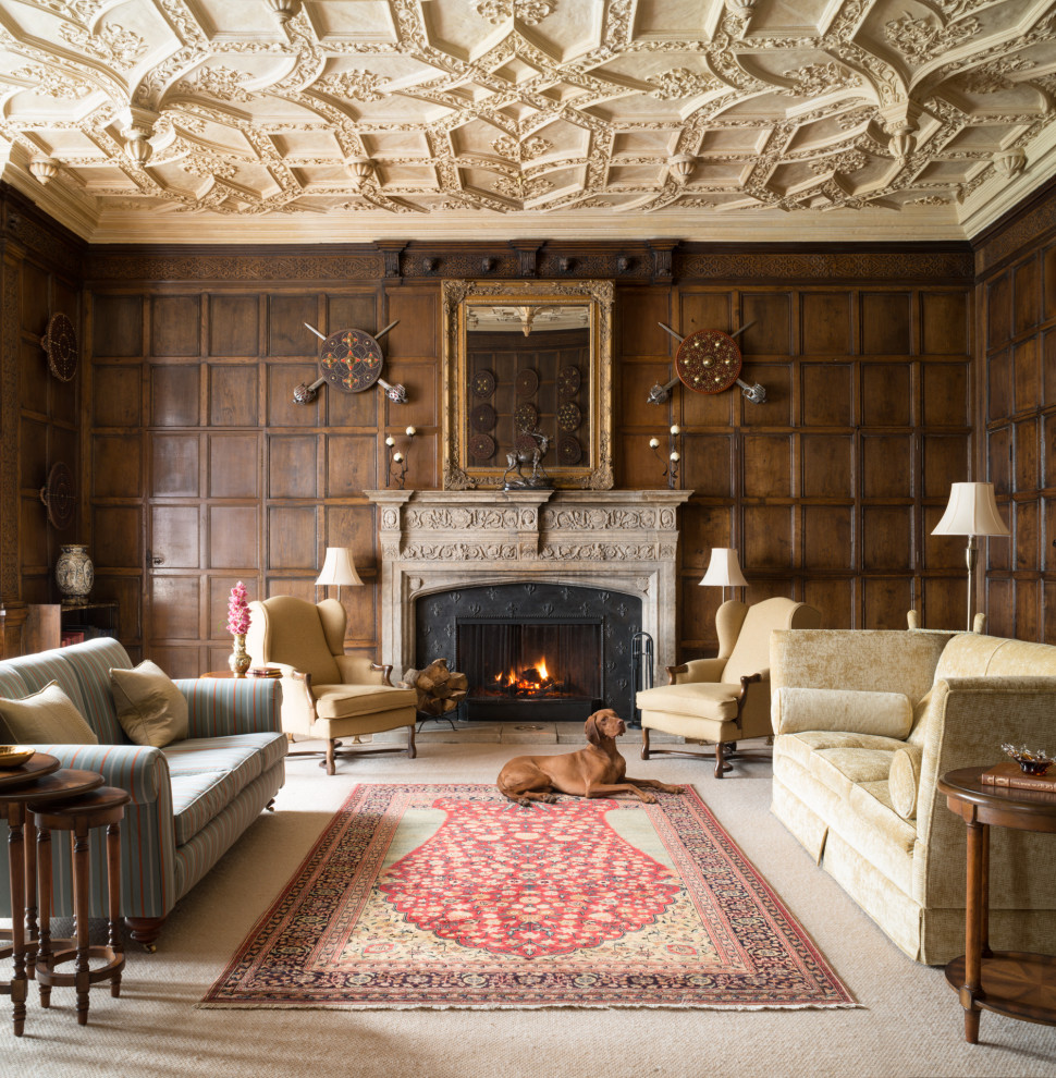 This is an example of a traditional formal enclosed living room with brown walls, carpet, a standard fireplace, beige floors, panelled walls and wood walls.