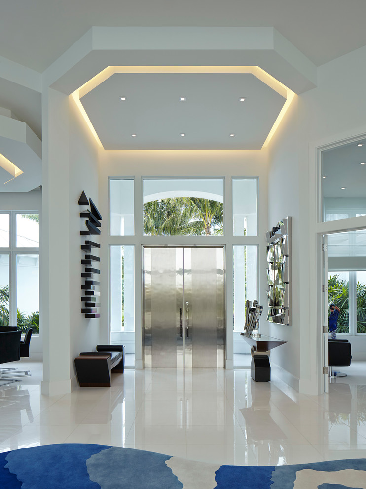 Contemporary foyer in Miami with white walls, a double front door, porcelain floors and a metal front door.
