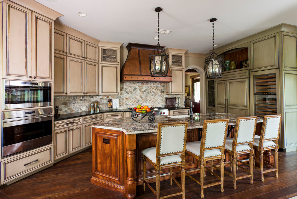 Inspiration for a traditional kitchen in Charlotte with an undermount sink, recessed-panel cabinets, beige cabinets, multi-coloured splashback, stainless steel appliances, dark hardwood floors and with island.