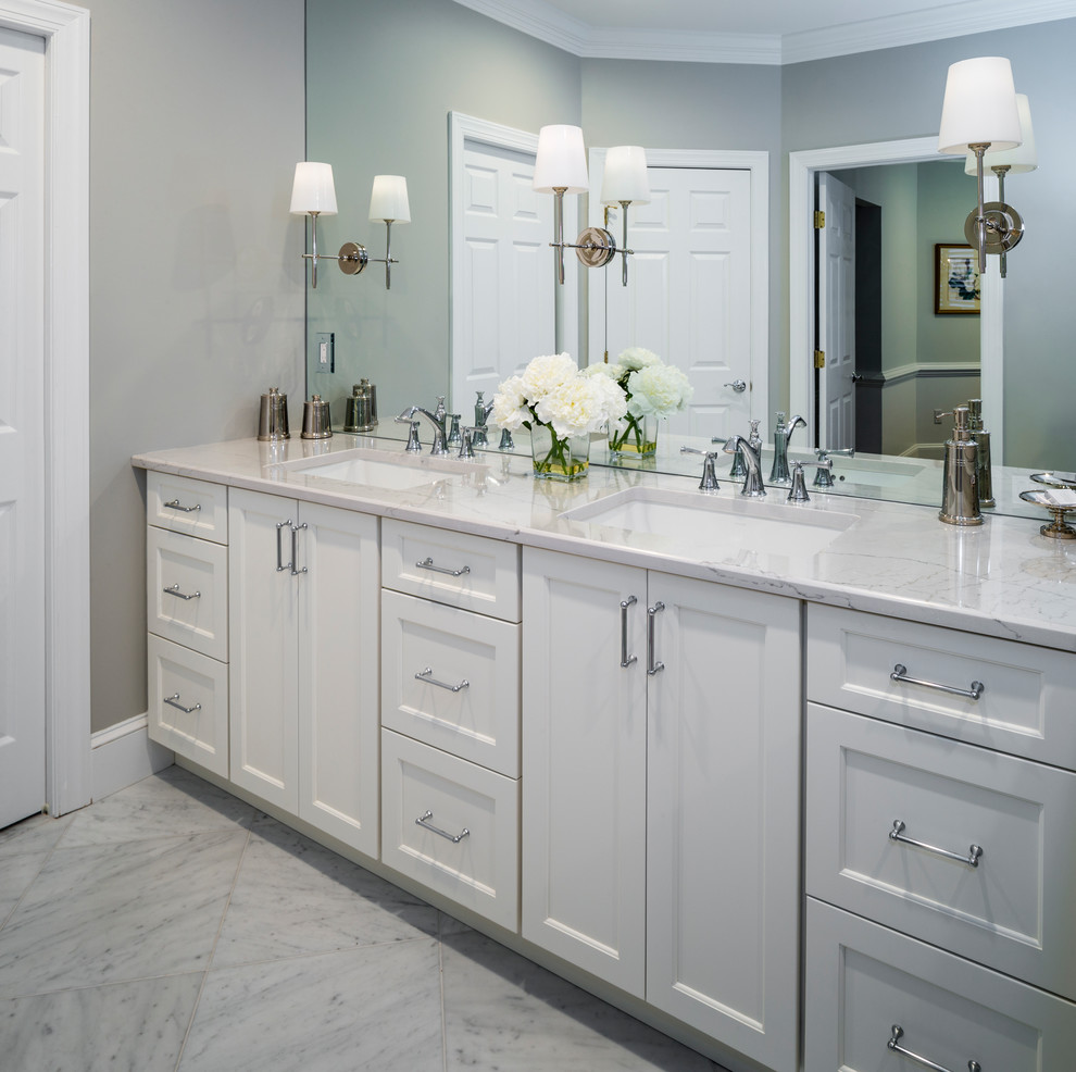 Large traditional master bathroom in Baltimore with beaded inset cabinets, white cabinets, a freestanding tub, a corner shower, a two-piece toilet, white tile, marble, grey walls, marble floors, an undermount sink, marble benchtops, white floor and a hinged shower door.