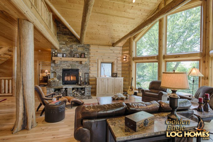 Inspiration for a large country loft-style living room in Other with medium hardwood floors, a standard fireplace, a stone fireplace surround, brown floor, brown walls and a concealed tv.