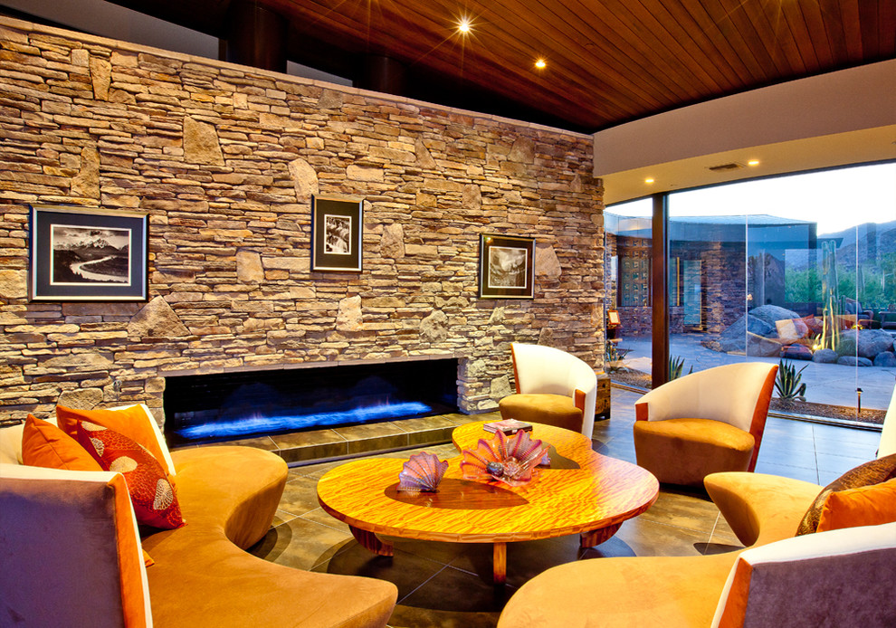 Contemporary living room in Phoenix with a ribbon fireplace, a stone fireplace surround and no tv.
