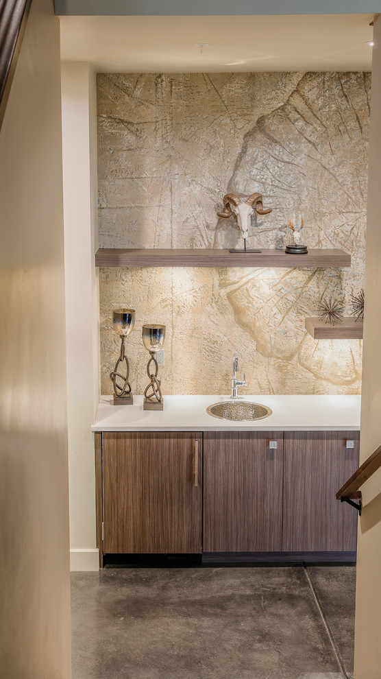 Inspiration for a contemporary single-wall wet bar in Denver with an undermount sink, flat-panel cabinets, medium wood cabinets, quartzite benchtops, brown splashback, stone slab splashback, concrete floors and brown floor.