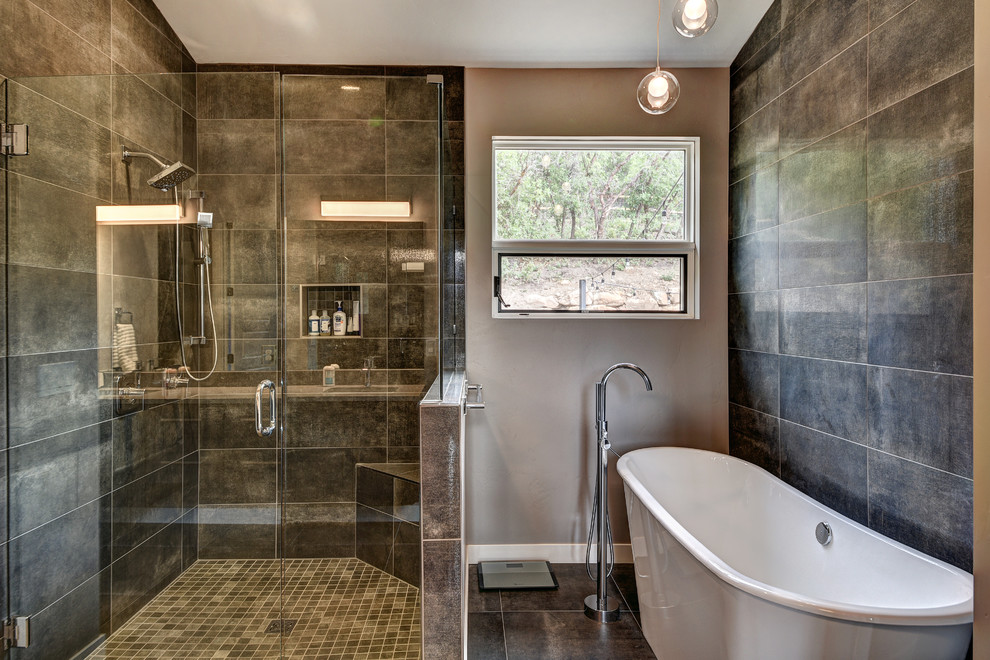 This is an example of a mid-sized modern master bathroom in Denver with a japanese tub, a corner shower, a one-piece toilet, grey walls, an undermount sink, a hinged shower door, flat-panel cabinets, grey cabinets, brown tile, brown floor and beige benchtops.