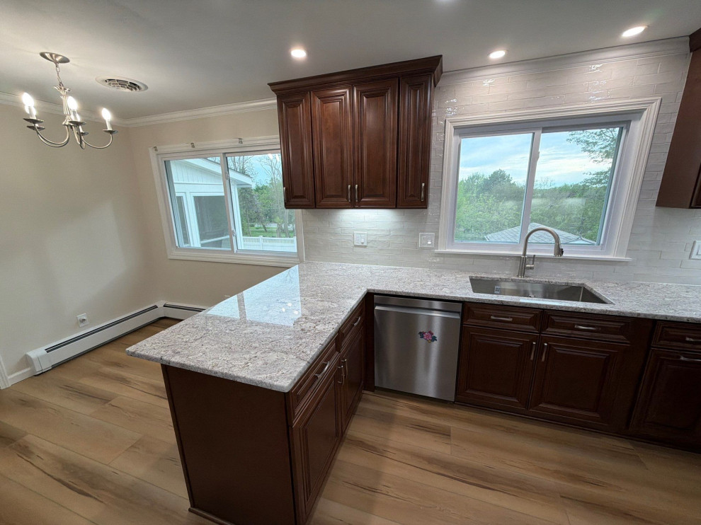 USCD cabinetry accompanied granite countertops, porcelain tile backsplash and Ca