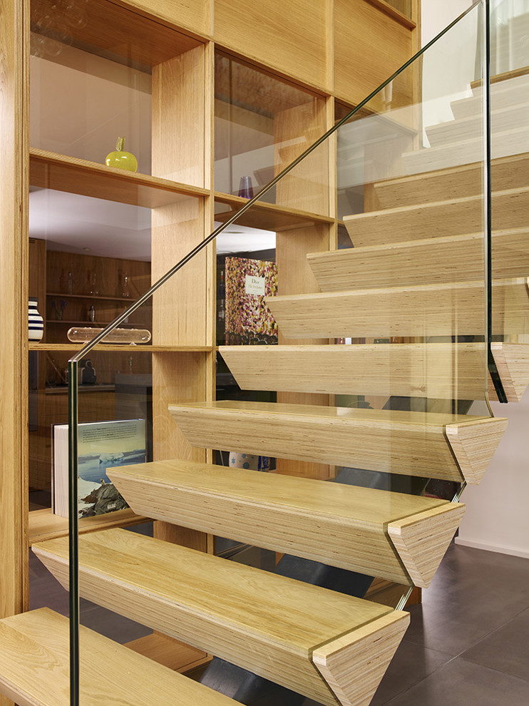 This is an example of a mid-sized contemporary wood straight staircase in London.
