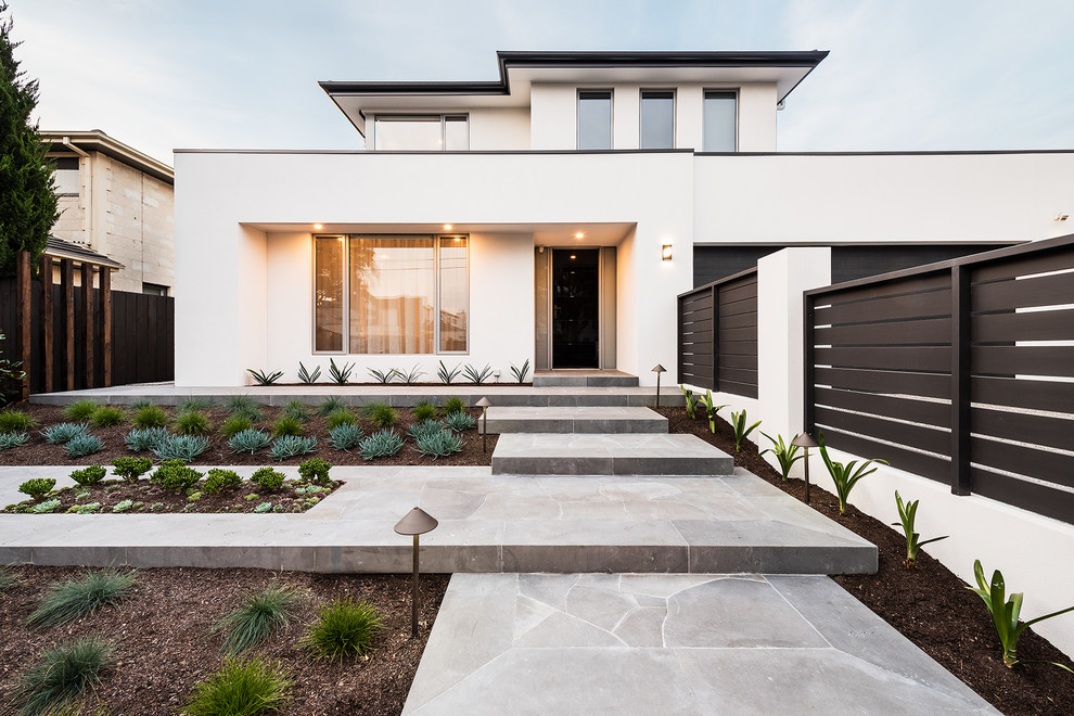 Mid-sized modern front yard garden in Melbourne with natural stone pavers.