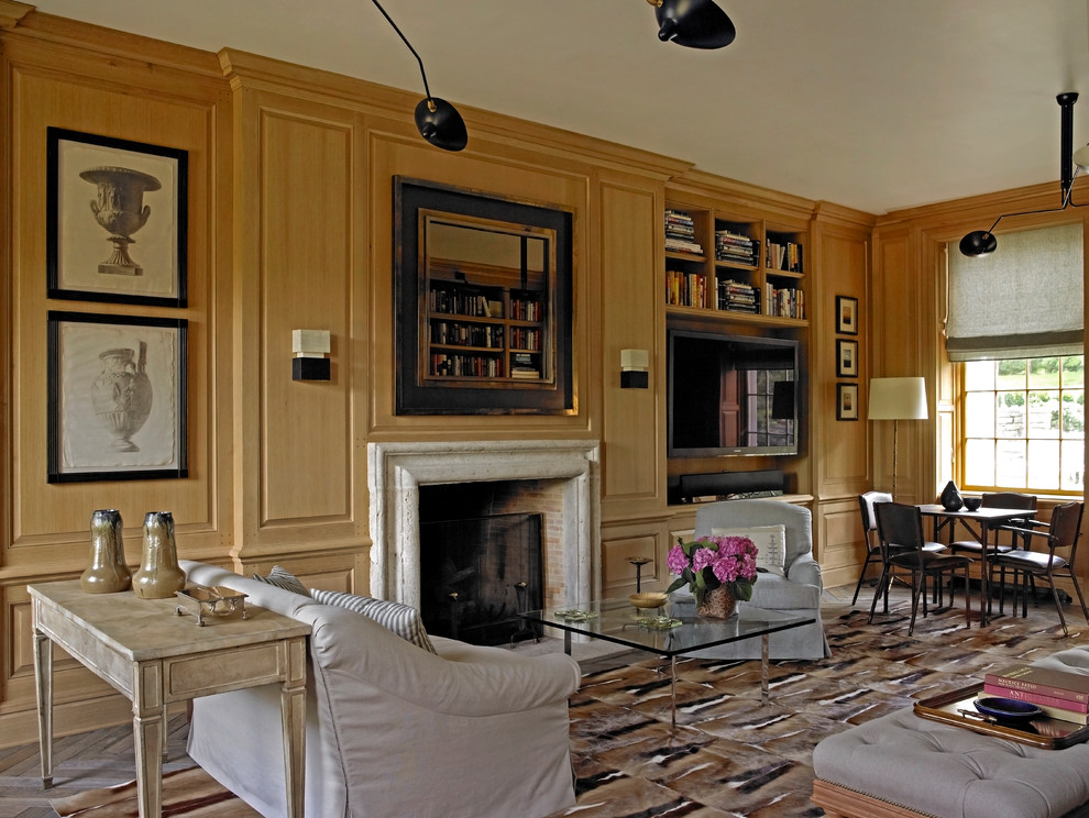 This is an example of a large traditional living room in New York with a library, brown walls, carpet and a wall-mounted tv.
