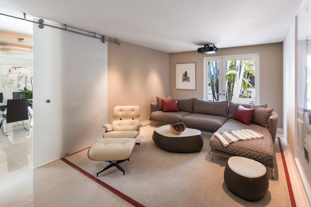 Contemporary enclosed home theatre in Los Angeles with beige walls, a projector screen and beige floor.