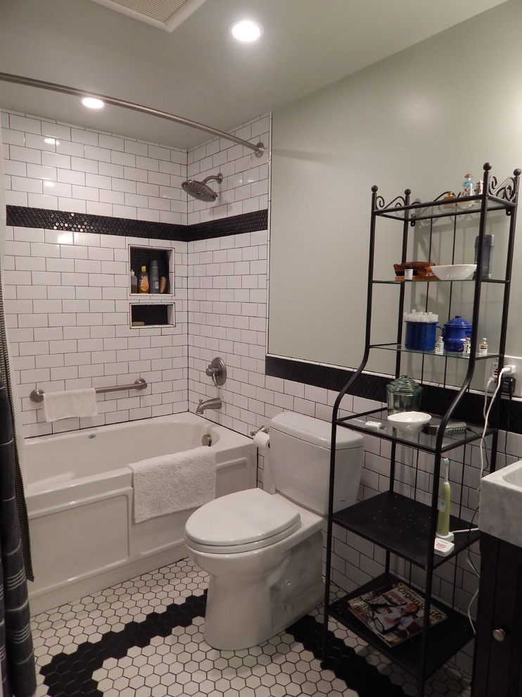Photo of a mid-sized traditional 3/4 bathroom in Denver with a vessel sink, furniture-like cabinets, dark wood cabinets, marble benchtops, an alcove tub, a two-piece toilet, white tile, ceramic tile, green walls, ceramic floors, a shower/bathtub combo, multi-coloured floor and a shower curtain.