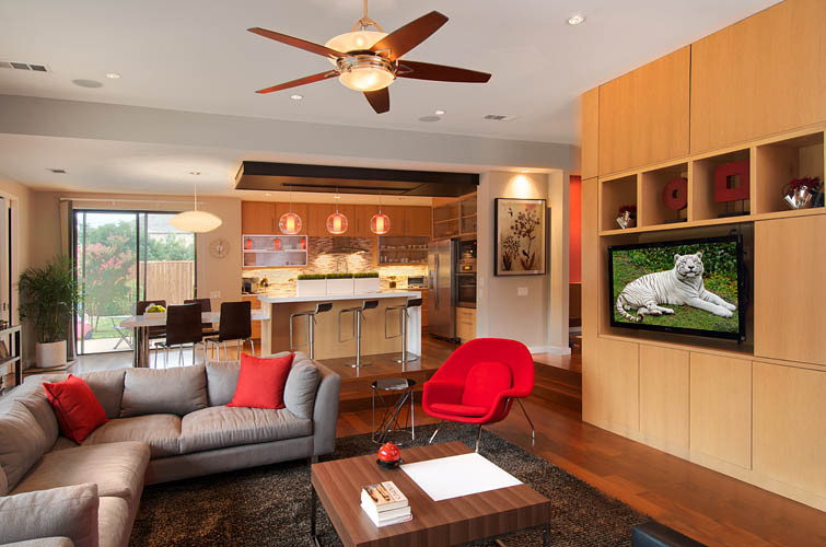 This is an example of a large contemporary open concept family room in Dallas with white walls, medium hardwood floors, a built-in media wall and brown floor.
