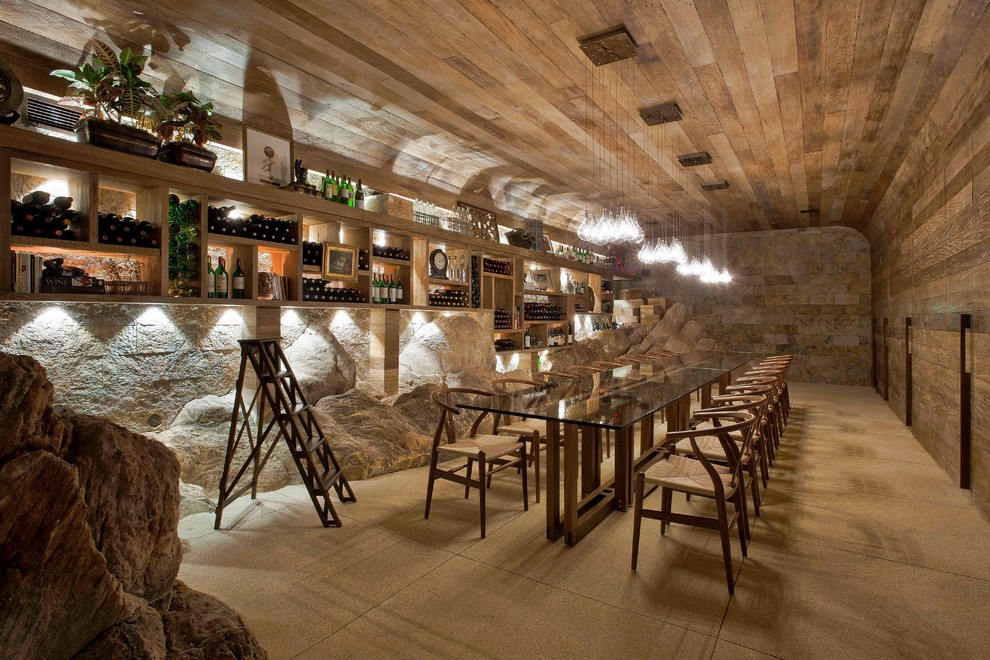 Inspiration for an expansive tropical wine cellar in Other with beige floor.