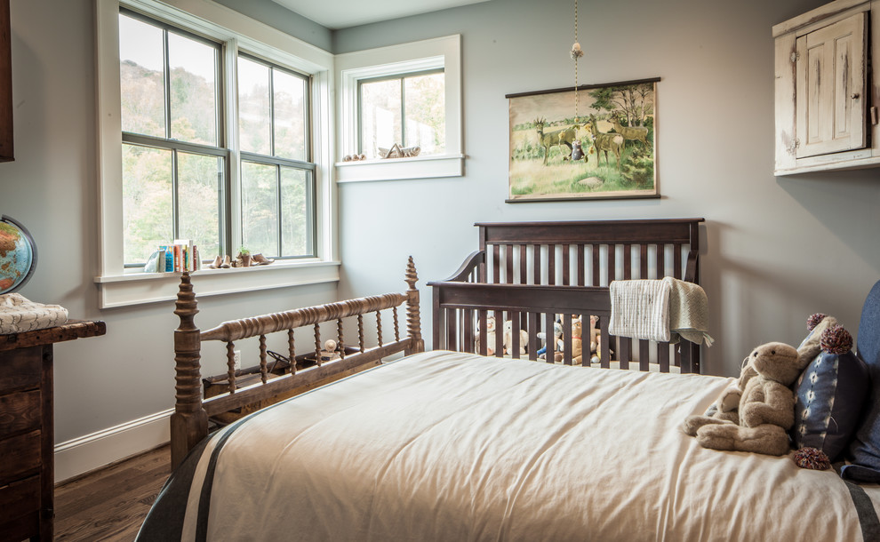 Photo of a mid-sized country gender-neutral nursery in Other with grey walls, dark hardwood floors and brown floor.