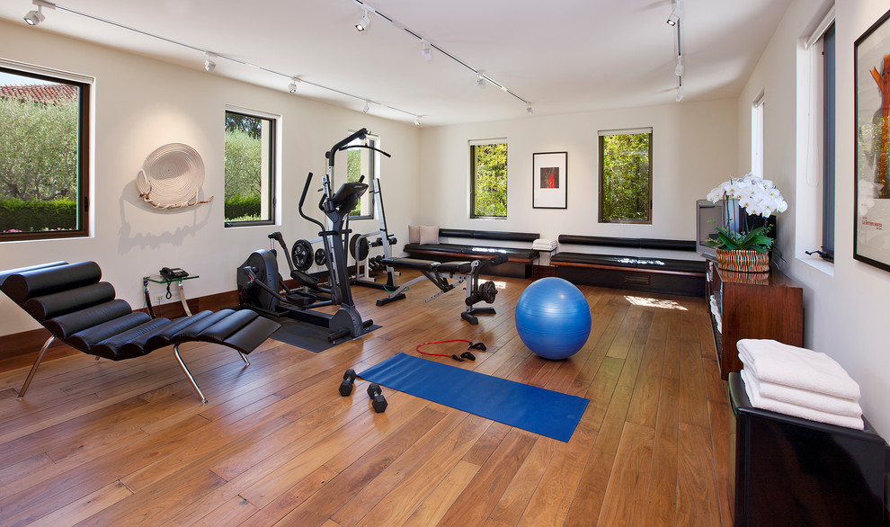 Design ideas for a mid-sized mediterranean home gym in Santa Barbara with dark hardwood floors and brown floor.