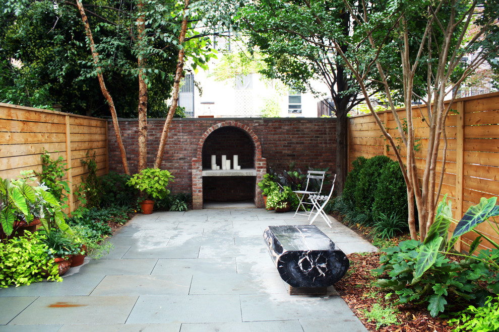 Inspiration for a contemporary backyard patio in New York with a fire feature.