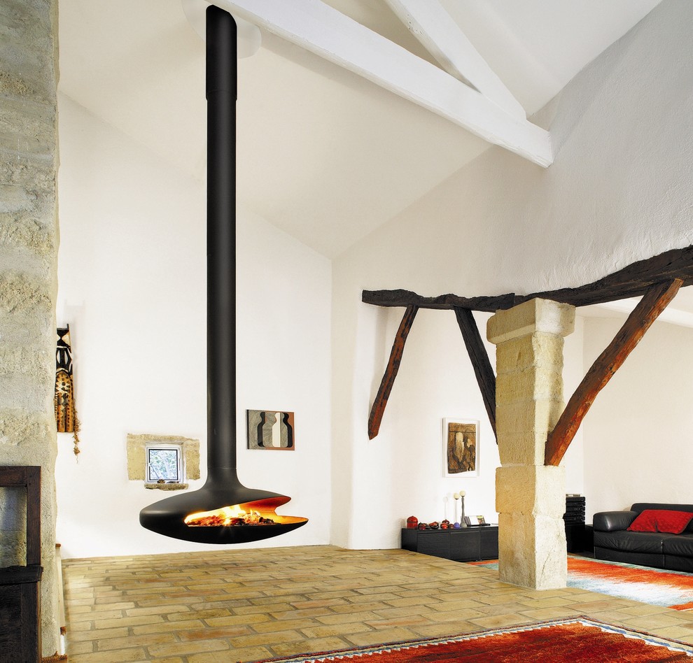 Inspiration for a country living room in Devon with brick floors and a hanging fireplace.