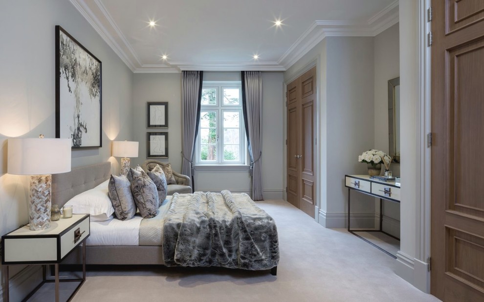 Large transitional bedroom in Berkshire with grey walls and grey floor.