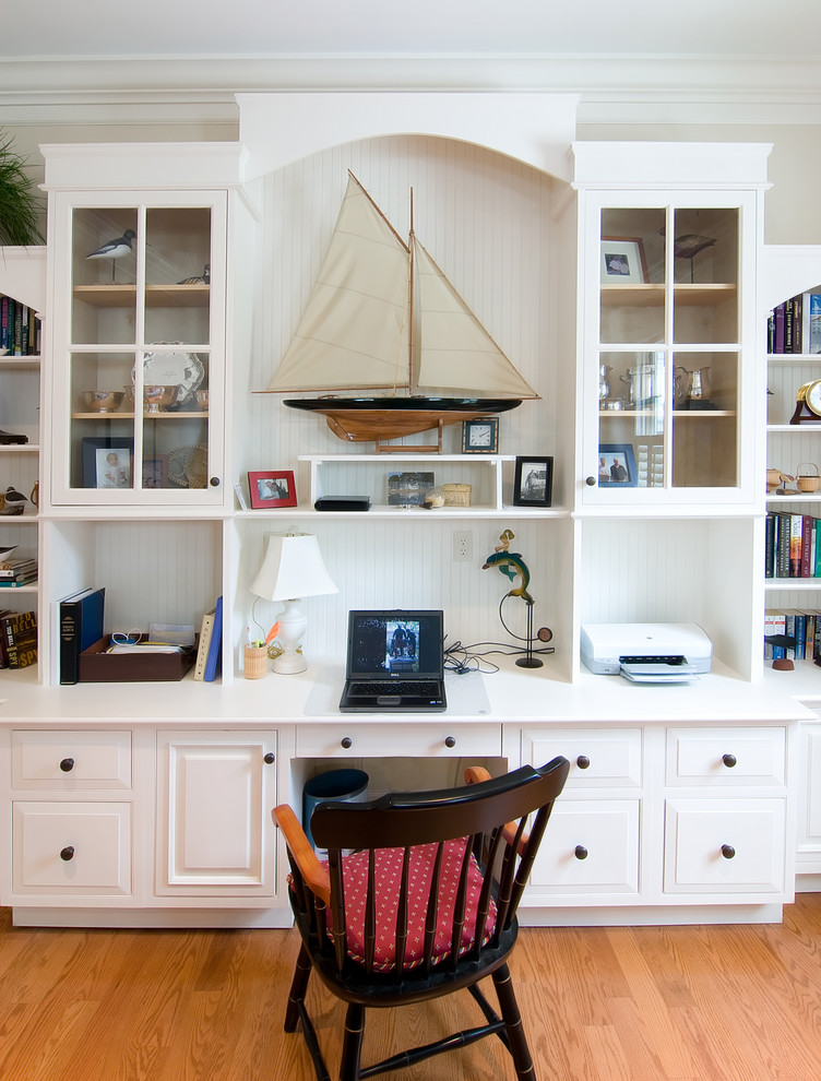 Inspiration for a traditional study room in Charleston with medium hardwood floors and a built-in desk.