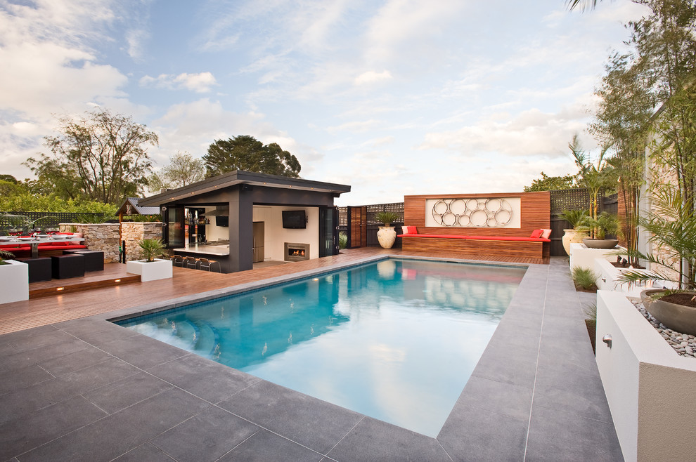 Large contemporary backyard rectangular lap pool in Melbourne with concrete pavers.