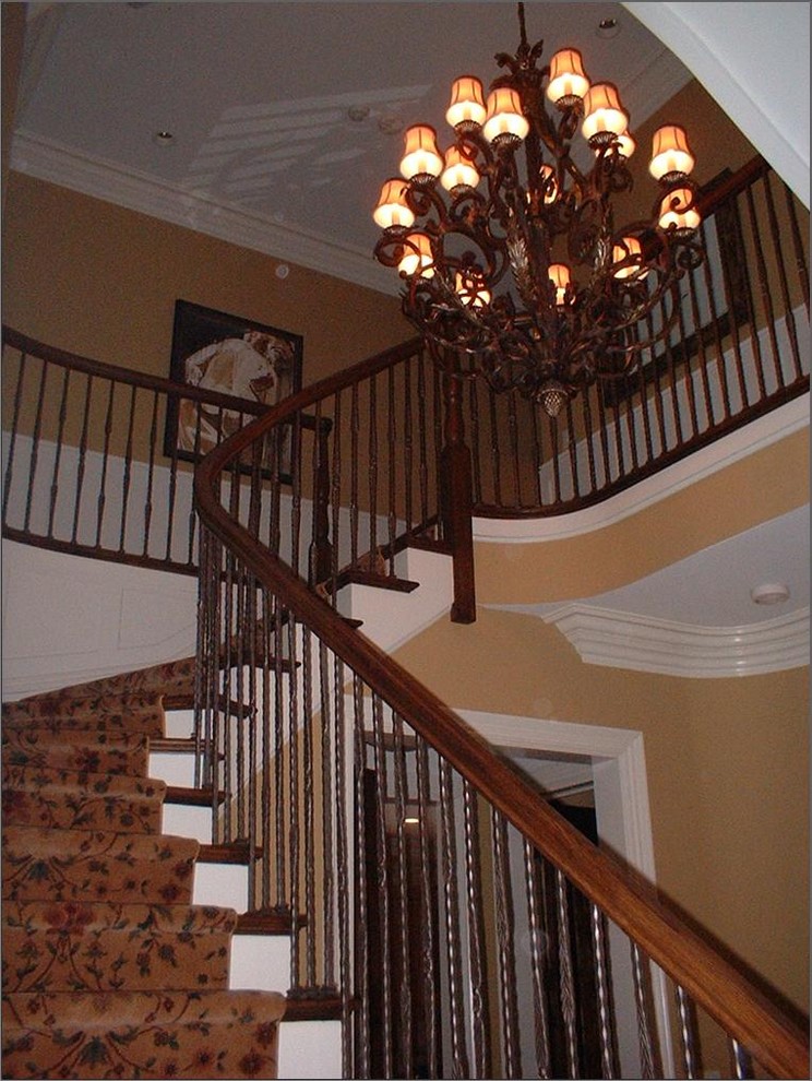 Staircase - huge traditional carpeted curved staircase idea in Chicago with painted risers