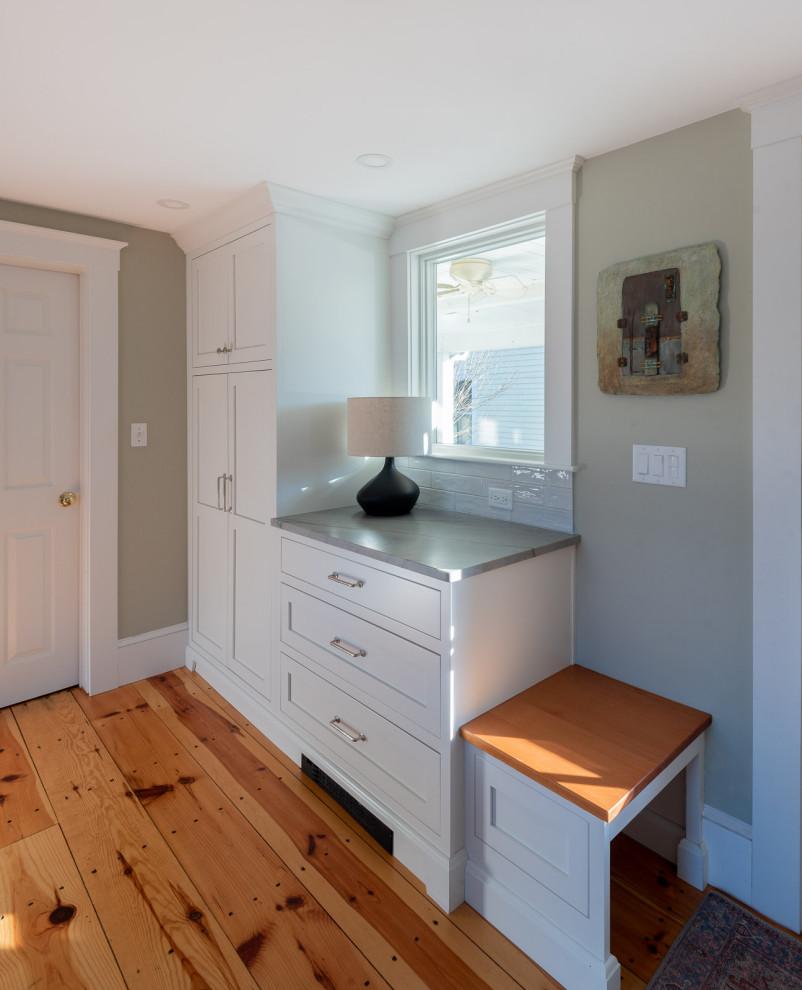 Large transitional galley light wood floor and brown floor eat-in kitchen photo in Boston with a farmhouse sink, shaker cabinets, white cabinets, quartzite countertops, white backsplash, ceramic backsplash, stainless steel appliances, an island and gray countertops