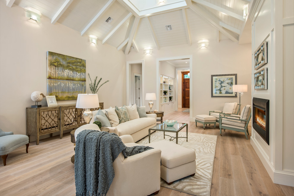 Living room - coastal formal and open concept light wood floor living room idea in Other with beige walls, a standard fireplace and a metal fireplace