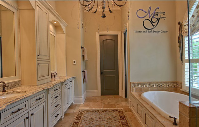 This is an example of a mid-sized traditional master bathroom in Atlanta with beaded inset cabinets, beige cabinets, a drop-in tub, a corner shower, beige tile, terra-cotta tile, beige walls, terra-cotta floors, an undermount sink and granite benchtops.