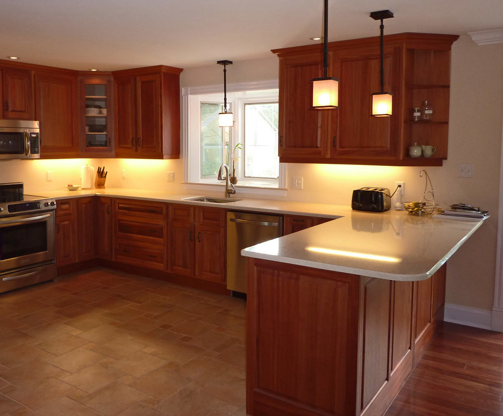 Open concept kitchen - mid-sized transitional u-shaped ceramic tile and beige floor open concept kitchen idea with a single-bowl sink, raised-panel cabinets, medium tone wood cabinets, quartz countertops, stainless steel appliances, a peninsula and beige countertops