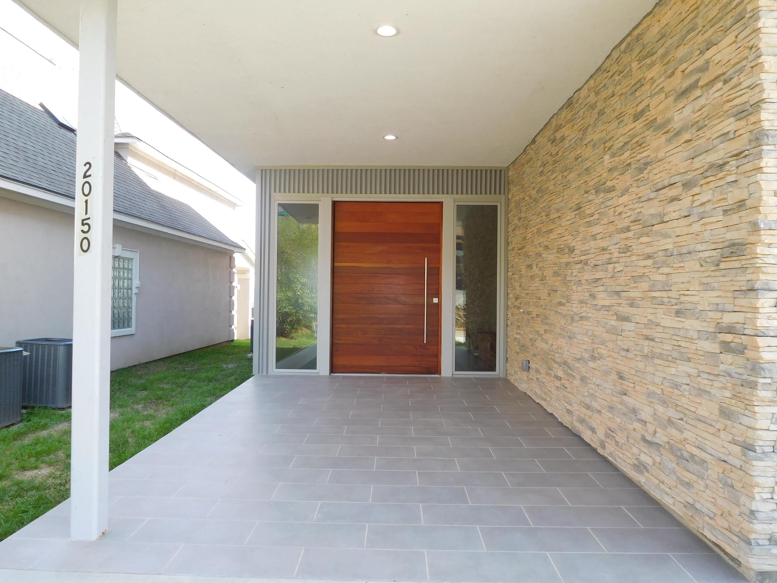 Covered entry with large pivot door