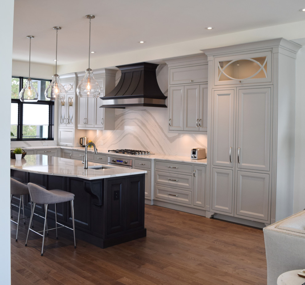 Inspiration for a large l-shaped medium tone wood floor and brown floor open concept kitchen remodel in Ottawa with an undermount sink, recessed-panel cabinets, white cabinets, quartz countertops, white backsplash, quartz backsplash, paneled appliances, an island and white countertops