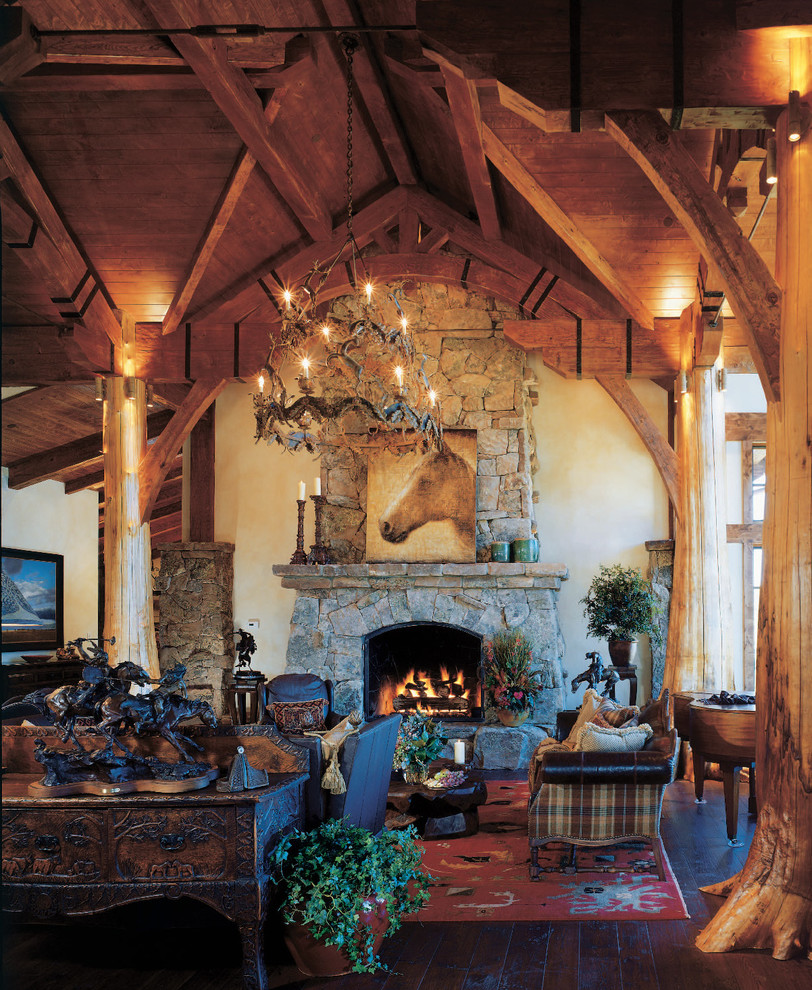 Country living room in Denver with a stone fireplace surround.