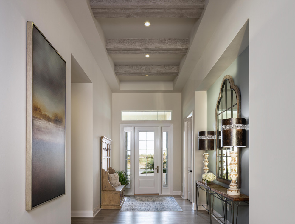 Design ideas for a transitional foyer in Miami with white walls, medium hardwood floors, a single front door, a white front door, brown floor and exposed beam.