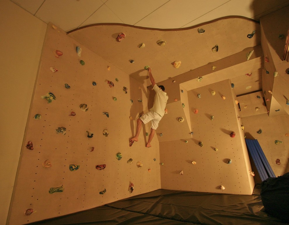 Eclectic home climbing wall in Minneapolis with beige walls.